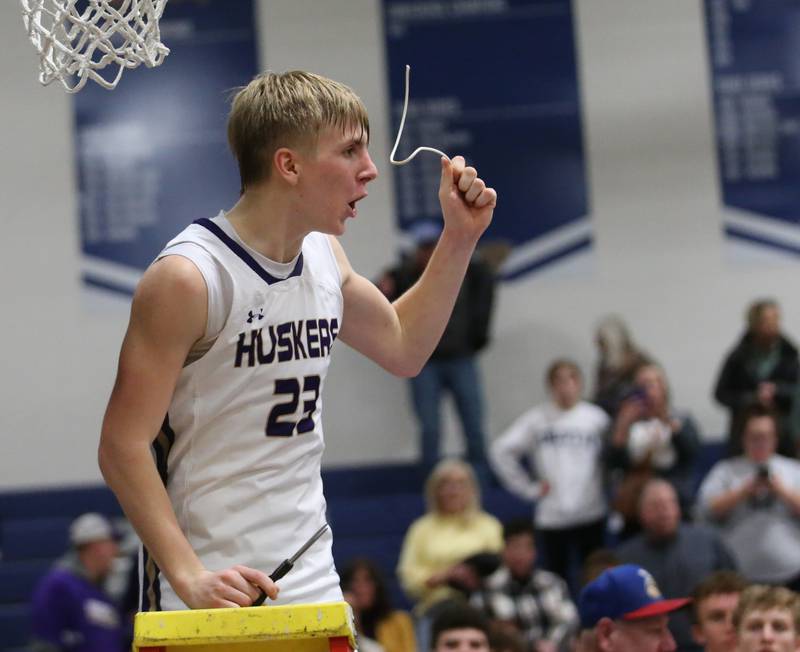 Serena's Tanner Faivre reacts after cutting down a piece of the net as the Huskers win the Little Ten Conference Championship on Friday, Feb. 2, 2024 at Somonauk High School.