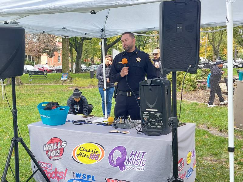Ottawa Police Capt. Kyle Booras talks Saturday, Oct. 14, 2023, during the Out of the Darkness Walk event about the mental health training Ottawa officers have taken.