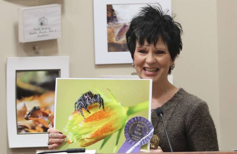 Katherine Buckley of Oglesby, holds her best of show photo of a jumping spider on a zinnia plant during the Starved Rock Photography Show awards on Saturday, Jan. 3, 2026 at the Starved Rock Visitors Center.
