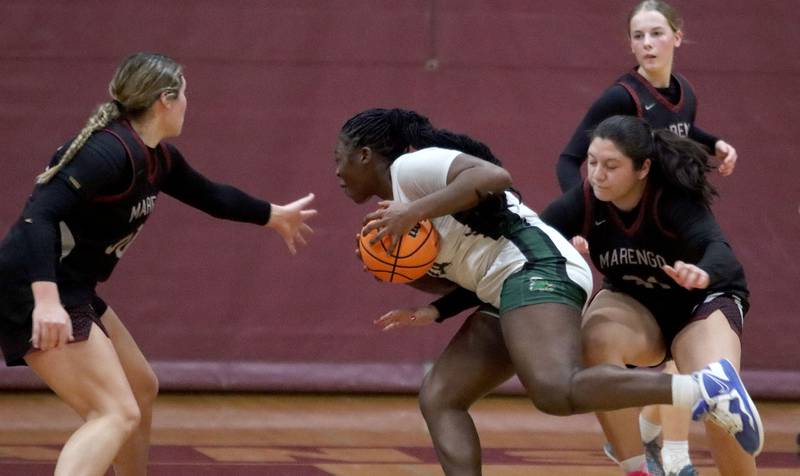 Marengo’s Macy Noe, left, and Ariana Rodriguez, right, guard St. Edwards’ Sanaii McPherson in IHSA Regional Championship girls basketball on Thursday, Feb. 19, 2026, at Marengo High School in Marengo.