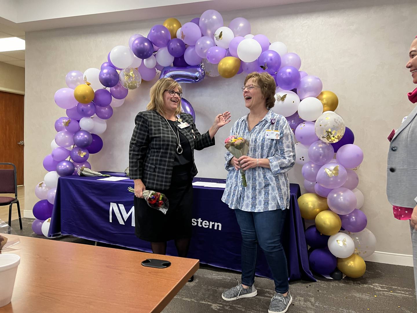 Kim Czaruk, director of operations, recognizes Cheri Johnson, care coordinator, at the five-year celebration for Northwestern Medicine Valley West Hospital’s Homeward Healing program.