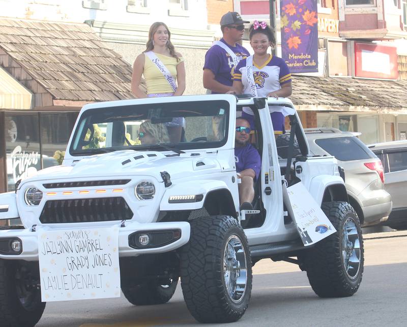 Mendota High School senior attendants Jazlynn Gambrel, Grady Jones and Laylie Denault ride down Indiana Avenue during the homecoming parade on Friday, Oct. 3, 2025
