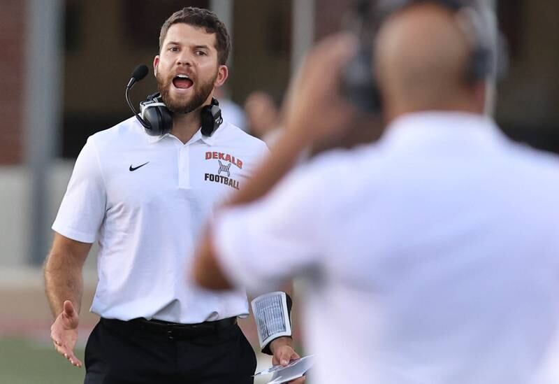DeKalb head coach Derek Schneeman gets the attention of his players during the First National Challenge against Sycamore Friday, Aug. 26, 2022, in Huskie Stadium at Northern Illinois University in DeKalb.