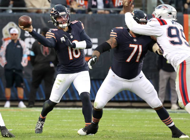 Chicago Bears quarterback Caleb Williams sidearms a pass through the Patriots defensive line during their game Sunday, Nov. 10, 2024, at Soldier Field in Chicago.