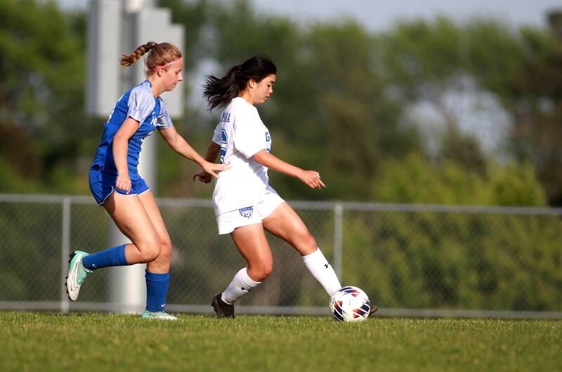 Geneva’s Leyna Yonehara (right) dribbles the ball during a Class 3A South Elgin Sectional semifinal game against Wheaton North on Tuesday, May 21, 2024.