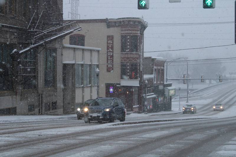 Cars move uphill slowly while experiencing poor traction after coming across the Galena Avenue Bridge during a winter storm on Thursday in Dixon.  Saturday's forecast for northern Illinois called for one to three inches of snow, but also for slushy accumulations on bridges and overpasses that could hinder motorists.