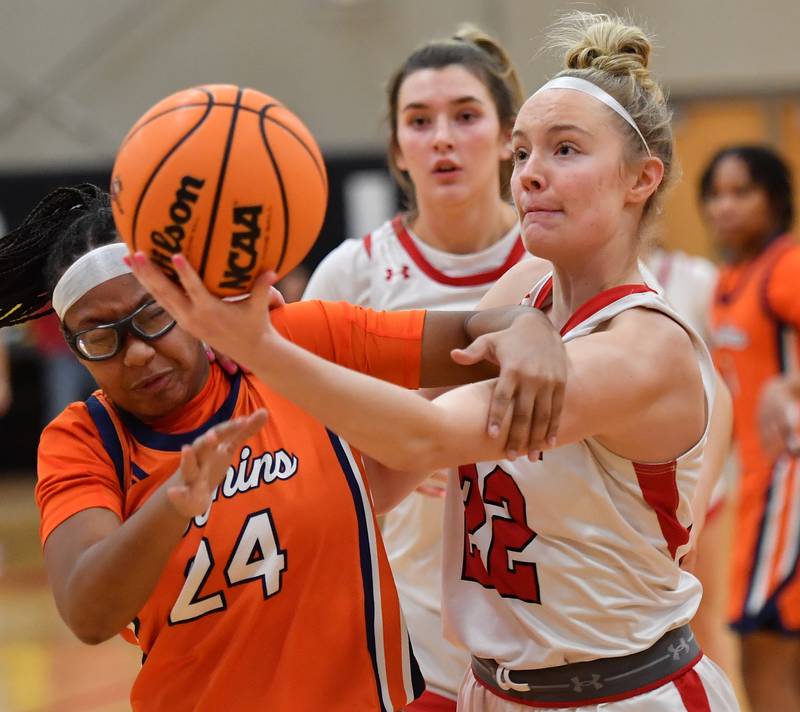 Benet’s Bridget Rifenburg (right) snags a rebound in front of  Whitney Young’s Harmony Cooper (24) as Redwing teammate Lucy Tierney watches from behind during a Coach Kipp Hoopsfest game on January 19, 2026 at Benet Academy in Lisle.