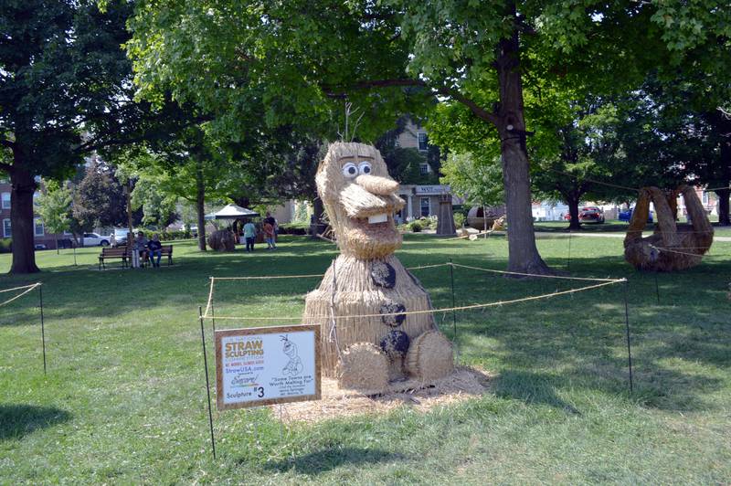 "Some Towns are Worth Melting For," by Jenna Springer, of Mt. Morris, on Saturday Aug. 24, 2024, sits on the Mt. Morris College Campus in the village's downtown. The straw sculpture was an entry in the ninth annual U.S. National Straw Sculpting Competition and won second place for People's Choice.