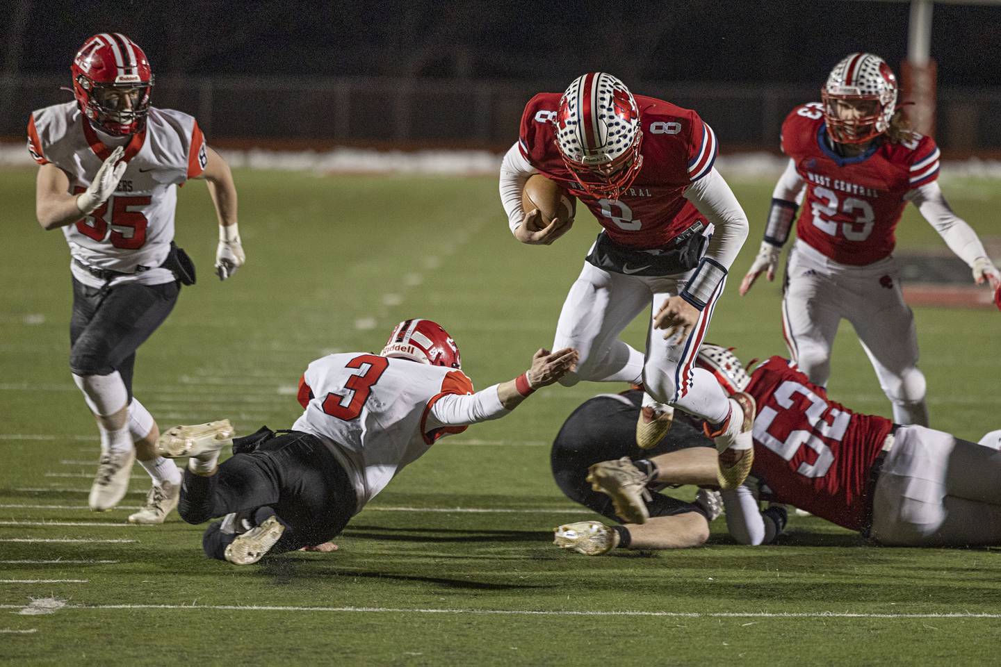 West Central’s Mason Carnes leaps over a tackler Friday, Nov. 18, 2022 in the 8-man championship football game against Amboy.