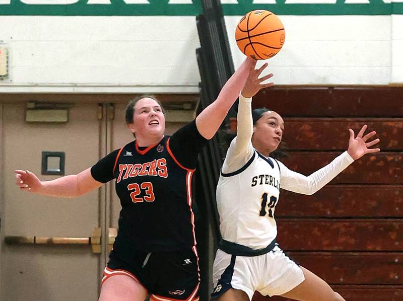 Crystal Lake Central's Leah Spychala (left) and Sterling's Nia Harris go after a loose ball during their Class 3A sectional semifinal game Tuesday, Feb. 25, 2025, at Boylan Catholic High School in Rockford.