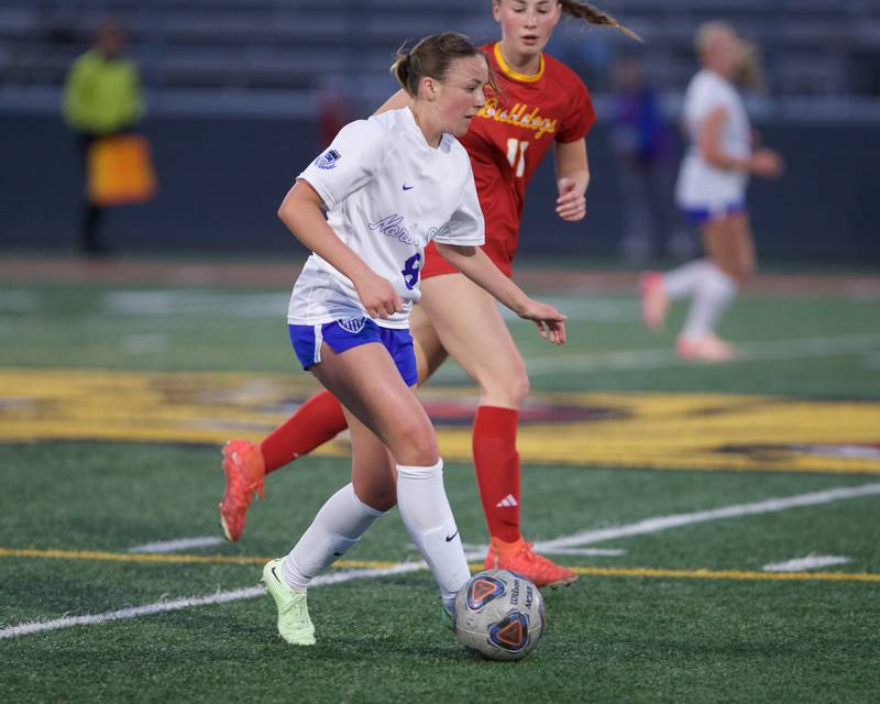 St. Charles North's Keira Kelly advances the ball downfield against Batavia's Hazel Gipson on Thursday, April 17,2025 in Batavia.