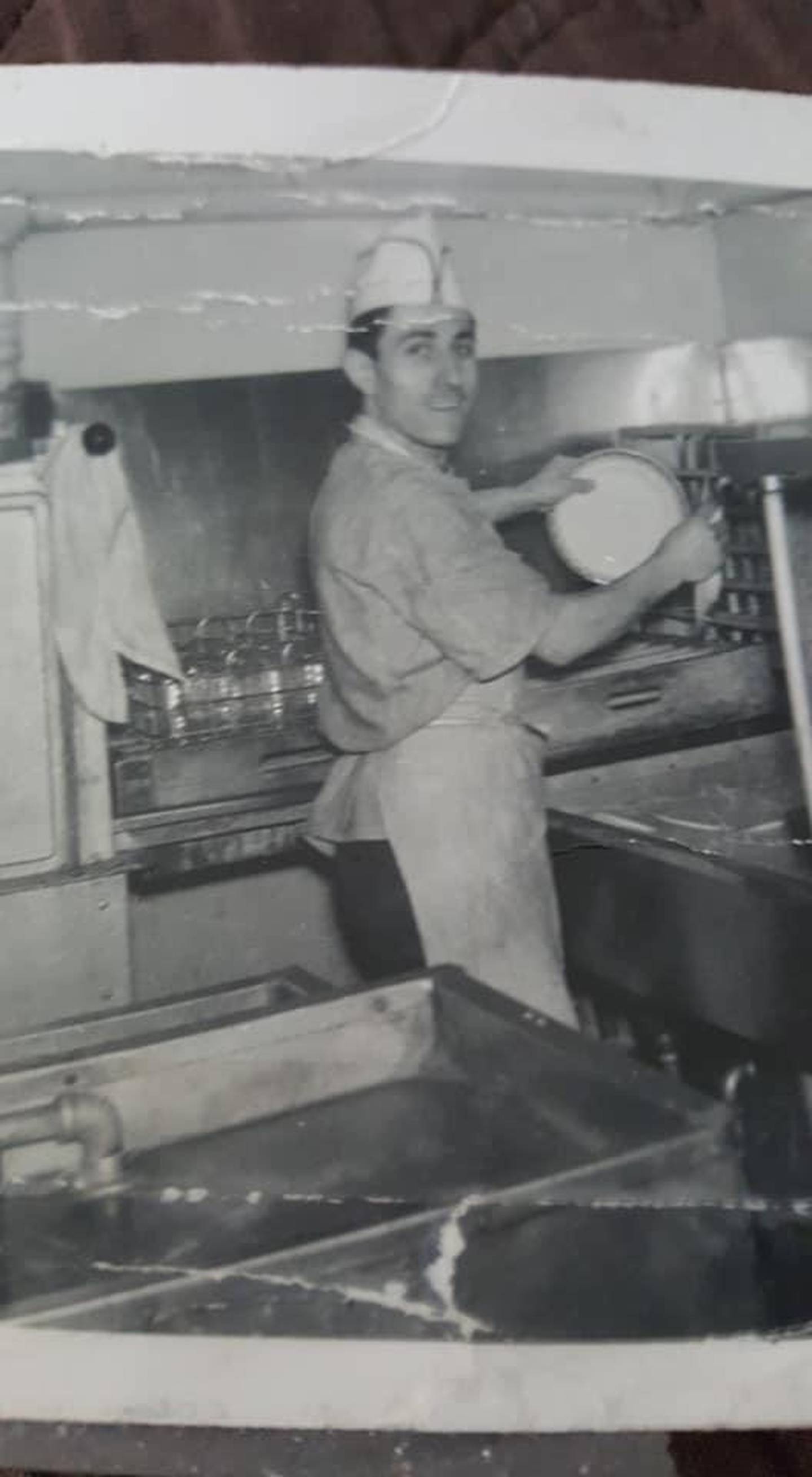 Andy's Restaurant founder Andrew Piculas is pictured in one of his first jobs in the restaurant industry as a dishwasher.