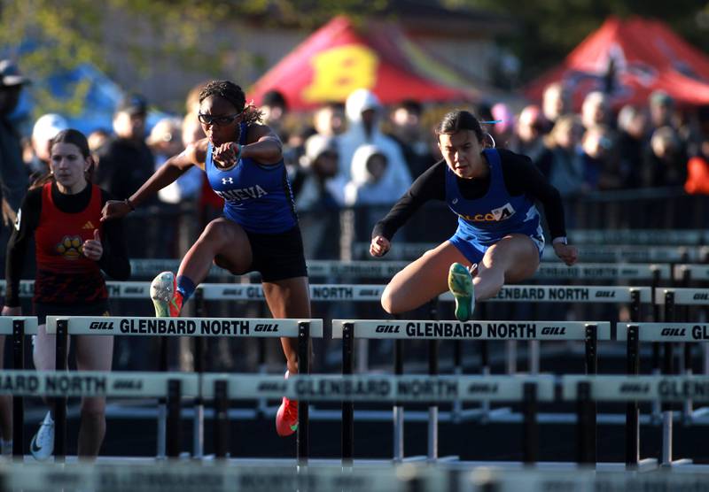Geneva’s Alyssa Flotte (center) and Wheaton North’s Sophia Dalrymple compete in the 100-meter hurdles during the DuKane Conference Girls Outdoor Championship on Thursday, May 8, 2025 at Glenbard North in Carol Stream.