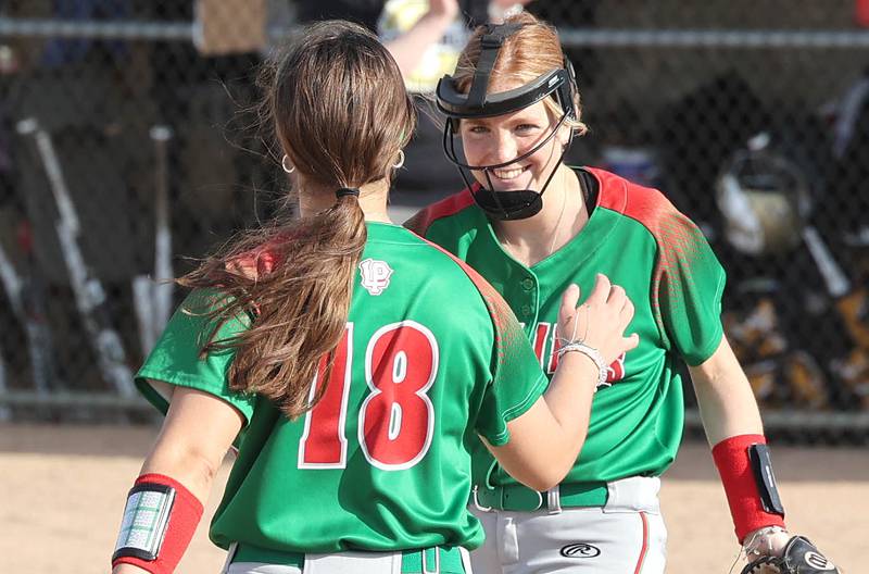 LaSalle-Peru's Chloe Mitchell (right) is congratulated by Evin Becker after striking out a Sycamore batter during their game Tuesday, April 11, 2023, at Sycamore High School.
