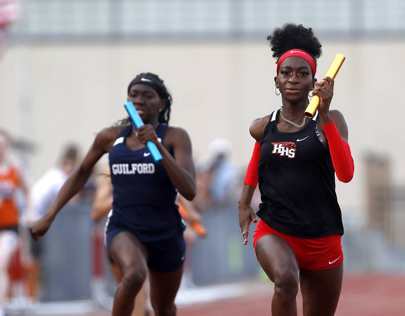Huntley’s Melissa Aninagyei-Bonsu runs through the finish line ahead of Guilford’s Jolena Sites to win the 4x100 relay during the IHSA Class 3A Huntley Girls Track Sectional Wednesday,  May 11, 2022, at Huntley High School.