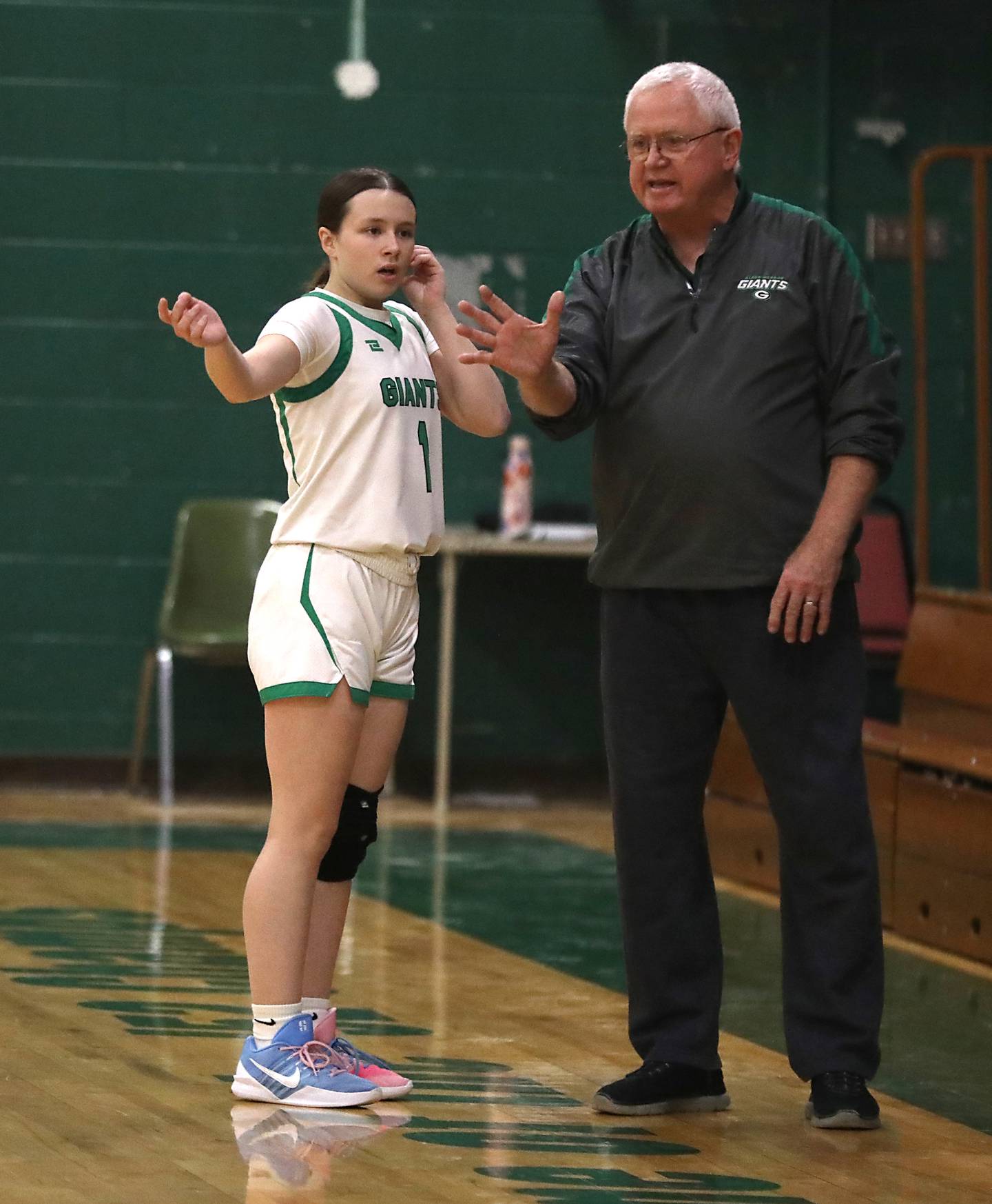 Alden-Hebron's Hayden Smith talks with coach Martin Hammond during a nononference girls basketball game against Woodlands Academy on Thursday, Jan. 29, 2026, at Alden-Hebron High School in Hebron.