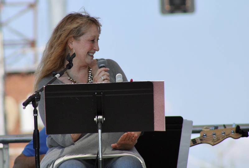 Lisa Allen-Grobe on vocals smiles before singing a number with Lyle Grobe and the Rhythm Ramblers on Sunday during the Petunia Festival.