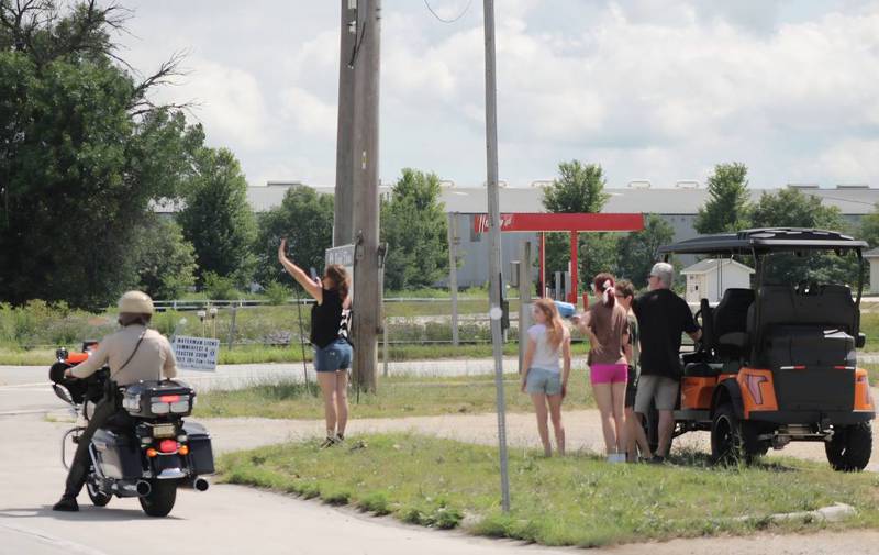 Onlookers wave to an incoming bicycle group made up of law enforcement and civilians on Saturday, July, 12, 2025, for Cycle Across Illinois, a charity campaign to honor fallen police officers and raise funds for their families.
