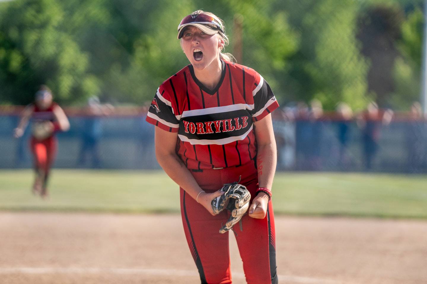 Yorkville's Madi Reeves (2) reacts after ending the game with a strike out to win the 4A sectional championship against Wheaton Warrenville South at Oswego High School on Friday, June 2, 2023.