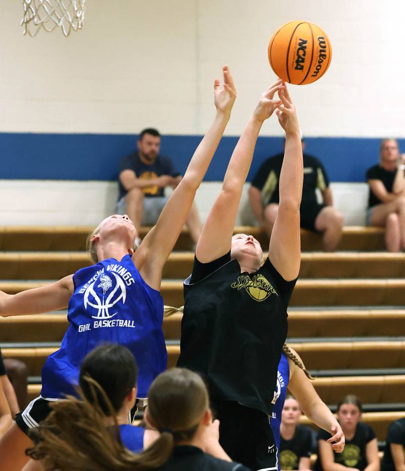 Geneva’s Emma Peterson (left) and Sycamore’s Cami Knox go after a rebound Thursday, June 12, 2025, in the Geneva High School Varsity Summer League.