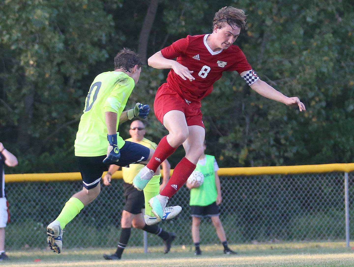 Streator's Noah Russow and Bloomington Central Catholic's keeper Emanuele Tameni leap in the air to go after the ball in a match last fall at St. James Street Recreation Area in Streator.