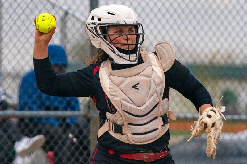 Yorkville catcher Kayla Kersting (10) throws to first after a strike out against Oswego during a softball game at Oswego High School on Tuesday, April 25, 2023.
