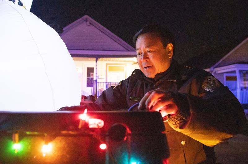 Kane County Field Training Officer Jeff Wong performs last-minute preparations on a float before the Holiday Homecoming Electric Christmas Parade in St. Charles on Saturday, Nov. 30, 2024.