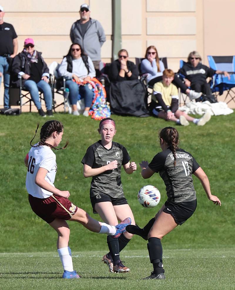 Morris' Abby Hanson kicks the ball between Sycamore's Cortni Kruizenga and Mariana Martinez during their Interstate 8 Conference Tournament semifinal game Wednesday, May 3, 2023, at Sycamore High School.