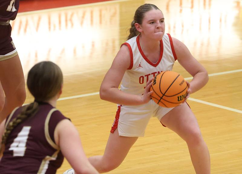 Ottawa's Kennedy Kane passes the ball around Morris's Brooke Thorson on Tuesday, Dec. 9, 2025 in Kingman Gymnasium at Ottawa High School.