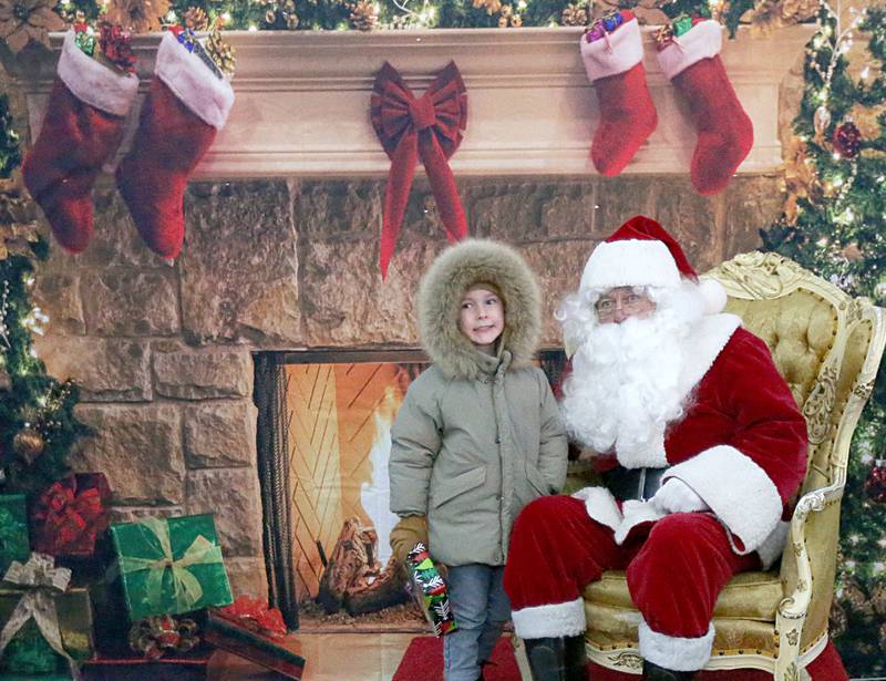 Elliot Clark 5, of Mendota visits with Santa during the Light up the Night parade on Saturday, Dec. 3, 2022 at Washington Park in Peru.