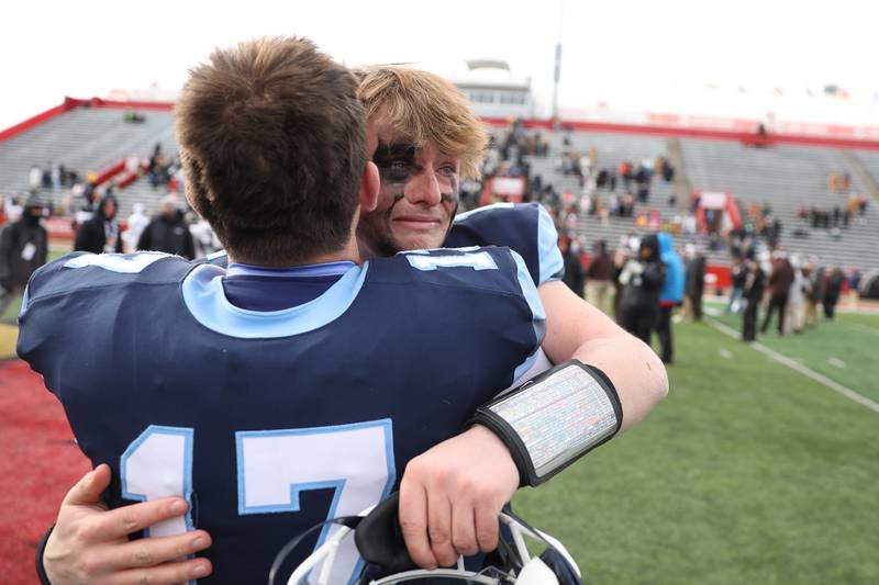 An emotional Logan Malachuk hugs his teammate Richards Skinkis after Nazareth defeated Joliet Catholic in the Class 5A state championship on Saturday, Nov. 30, 2024 in Normal.