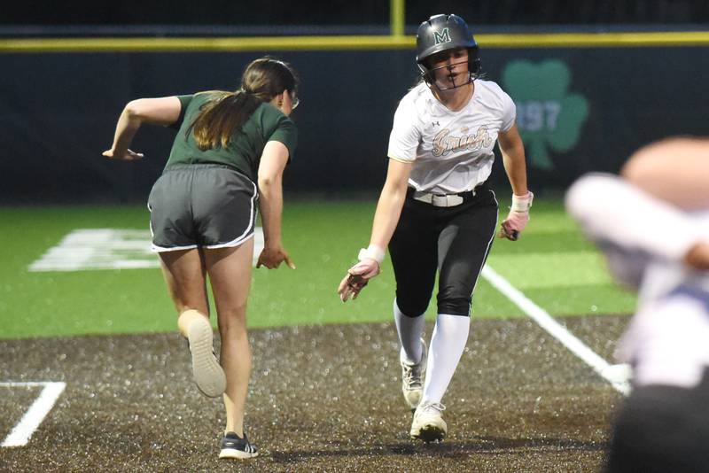 Bishop McNamara's Joslynn Dole, right, high fives coach Jenna Arseneau as she rounds third on her home run trot in the ninth inning of the Class 2A Seneca Regional semifinals against Wilmington Tuesday, May 19, 2026.