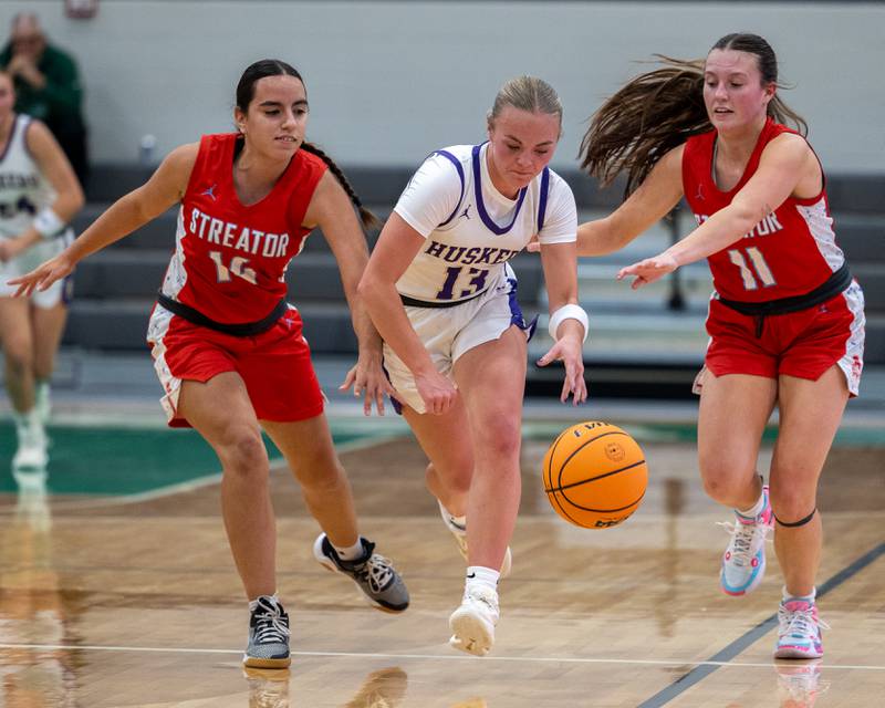 Brynley Glade (13) of Serena dribbles ball as (left) Isabel Gutierrez (14) of Streator and teammate (right) Ava Gwaltney (11)  defend on Monday, November 17, 2025 at Seneca High School in Seneca.
