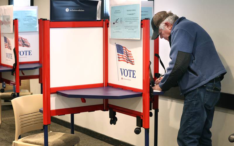 Mike Knowlton, from DeKalb, casts his ballot Tuesday, March 19, 2024, in the polling place at the DeKalb County Administration Building in Sycamore.
