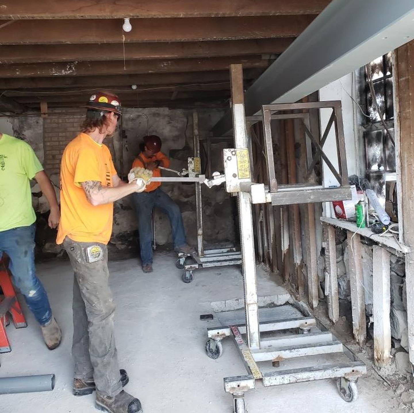 Workers repair the foundation of Richmond's Old No. 90 house in June. The house, the oldest building in town, set to become a museum and offices for the W.A. McConnell Foundation.