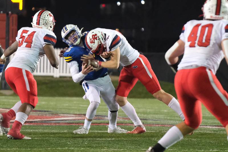 St. Ritas Pat Farrell sacks Mark Forcucci of Wheaton North in the Class 7A state championship at NIU Huskie Stadium. Saturday, Nov. 27, 2021 in Dekalb.