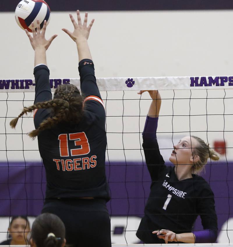 Hampshire's Elizabeth King (right) tries to hit the ball over the block of Crystal Lake Central's Siena Smiejek during a Fox Valley Conference volleyball match on Tuesday, Sept. 24, 2024, at Hampshire High School.