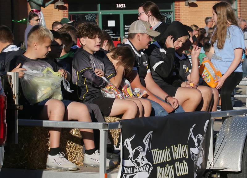 Illinois Valley Rugby Club players ride in the Homecoming parade on Friday, Sept. 30, 2022 downtown Peru.