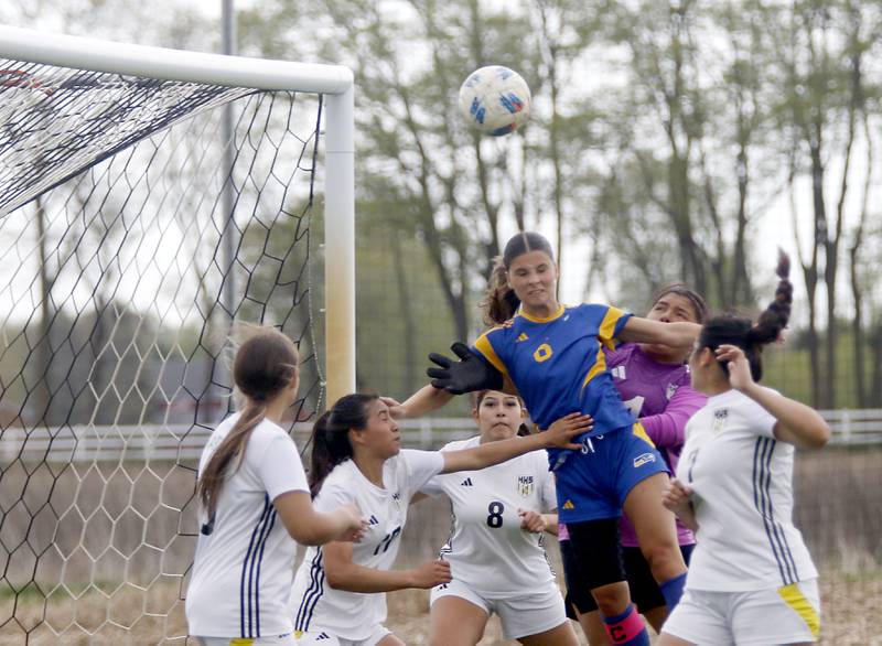 Johnsburg's Liz Smith tries to head the ball into the goal as she is surrounded by Harvard players during a Kishwaukee River Conference soccer match on Wednesday, April 27, 2026, at Johnsburg High School.