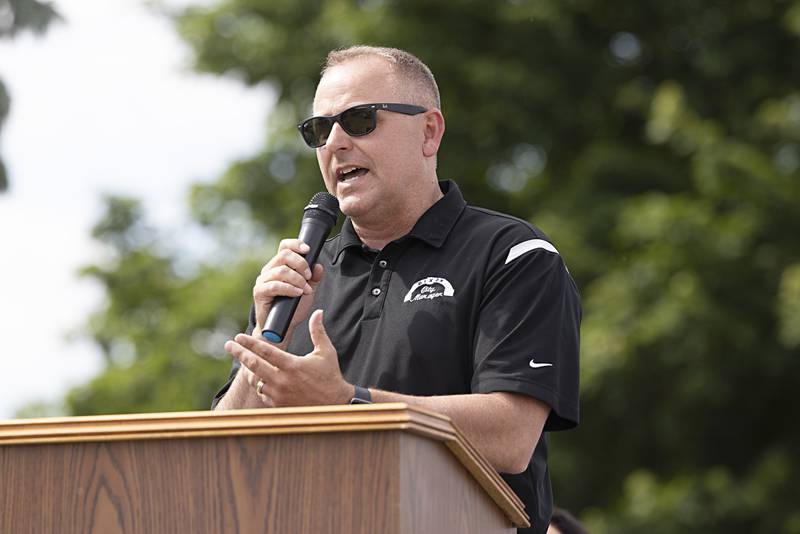 Dixon City Manager Danny Langloss speaks to the crowd during a ceremony naming the road in front of Dixon High School as “Mark Dallas Way” on Tuesday, May 30, 2023.