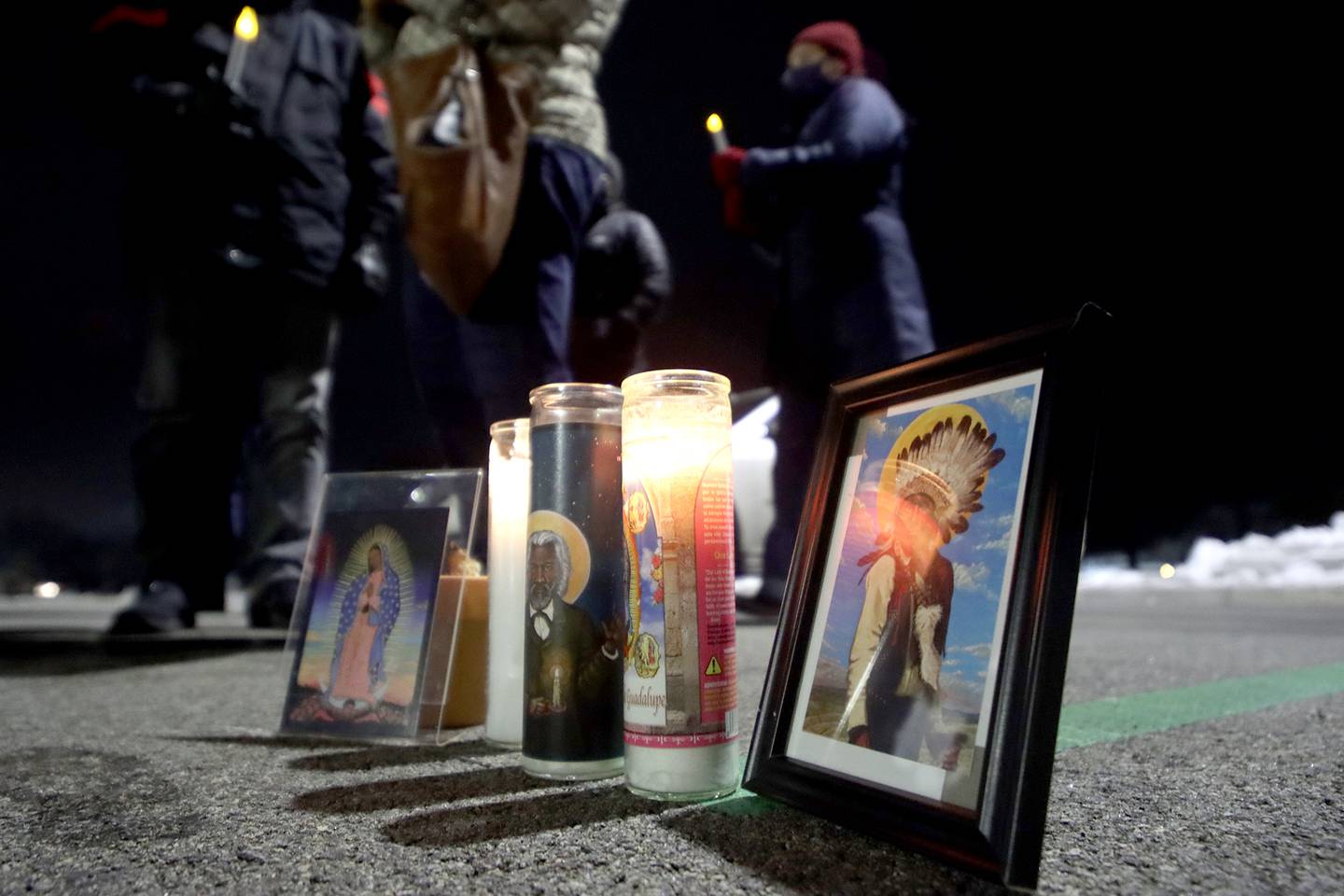 Activists held a candlelight march to the front of the McHenry County Correctional Facility the evening of Wednesday, Dec. 29, 2021, using a bullhorn to offer encouraging words to inmates and detainees. Former detainee Cesar Elizarraraz spoke to those gathered as part of the event arranged by the Coalition to Cancel the ICE Contract in McHenry County.