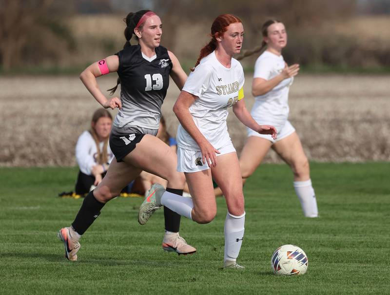 Sycamore's Isabelle Segreti runs ahead of Kaneland's Kyra Lilly during their game Monday, April 13, 2026, at Kaneland High School.