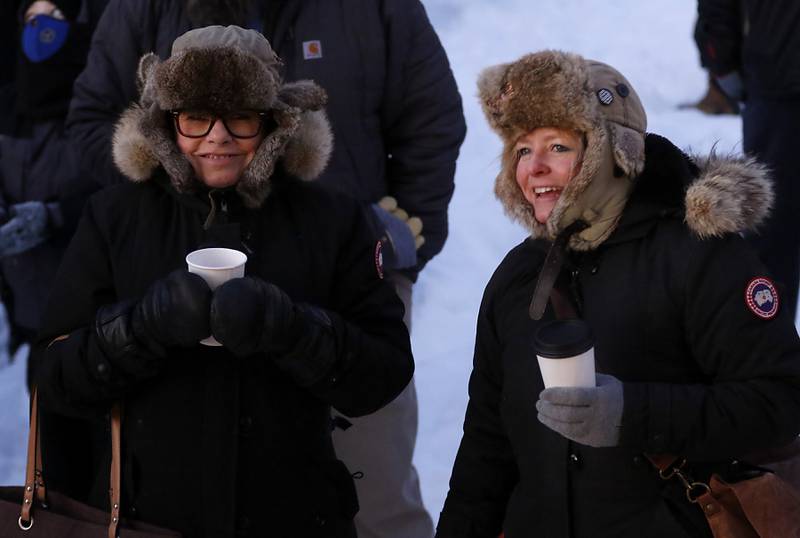 Kathleen Maki and Woodstock resident Elesha Werhane keep warm as they enjoy the festivities Thursday, Feb, 2, 2023, during the annual Groundhog Day Prognostication on the Woodstock Square.