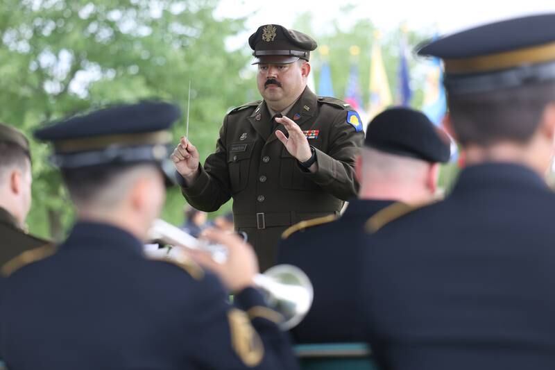 A conductor leads the IL Army National Guard’s 144th Army Band during the National Cemetery Administration 50th Anniversary ceremony at the Abraham Lincoln National Cemetery in Elwood on Saturday, July 29.