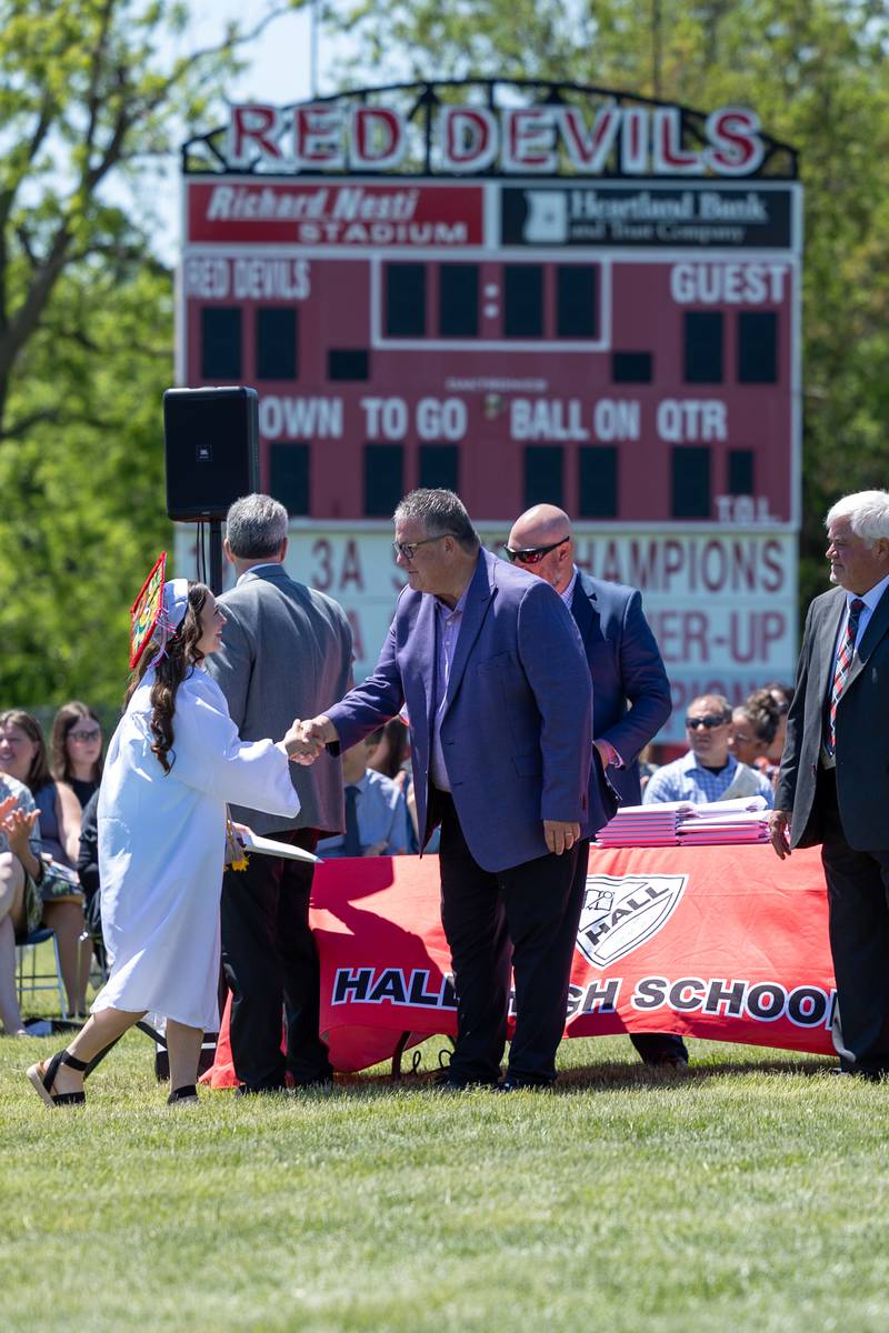 Graduate shakes hand of Administrator on Sunday, May 18, 2025 at Hall High School in Spring Valley.
