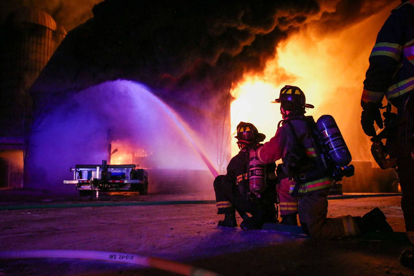Firefighters work on controlling a barn fire at the 10800 block of Carls Road near Marengo in the early hours of Christmas Eve.