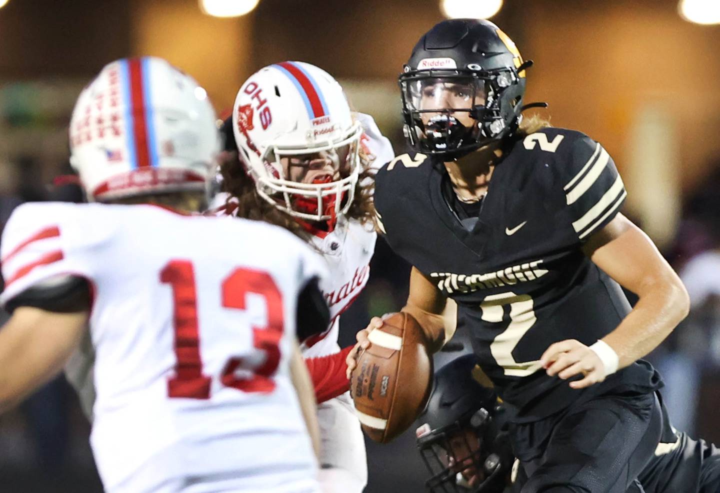 Sycamore's Elijah Meier looks for a receiver as he is pressured by the Ottawa defense during their game Friday, Sept. 16, 2022, at Sycamore High School.