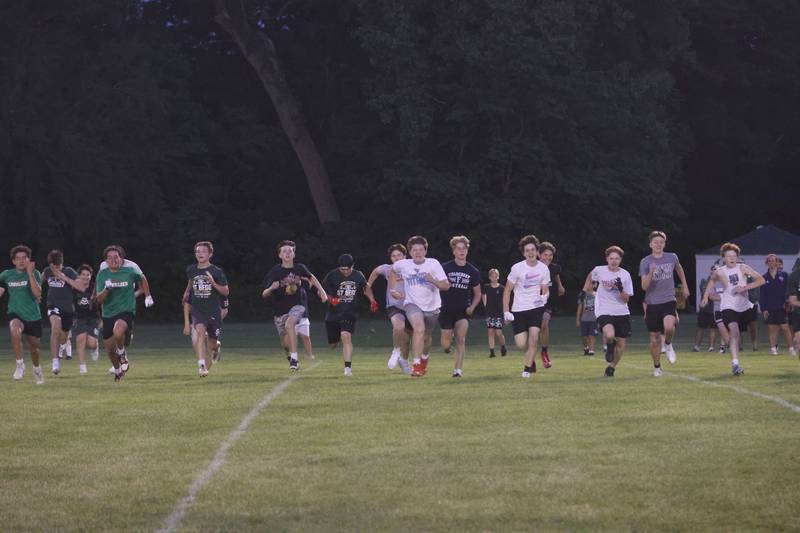 Kids run across the football field during the Tyson Bagent Offensive Skills Camp on Saturday, May 23, 2026 at St Bede Academy.