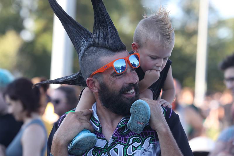 Floyd Ridener, from Mokena, enjoys music with his son Kaos, 2 years-old, on day three of Riot Fest. Sunday, Sept. 19, 2022, in Chicago.
