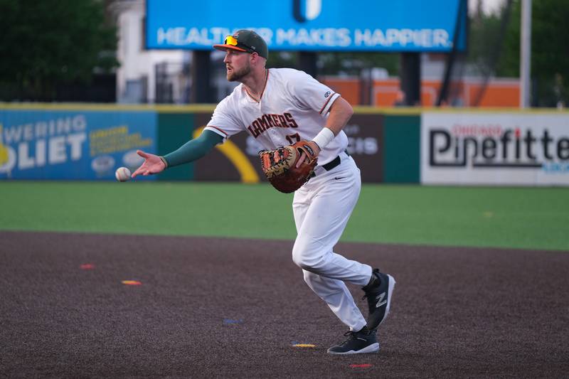 Joliet Slammers’ Luke Mangiere flips the ball to first base for the out against the Ottawa Titans. Friday, May 13, 2022, in Joliet.